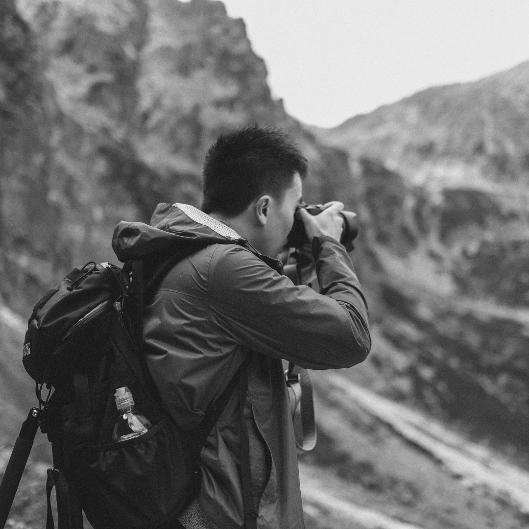 Photographer taking picture in mountains